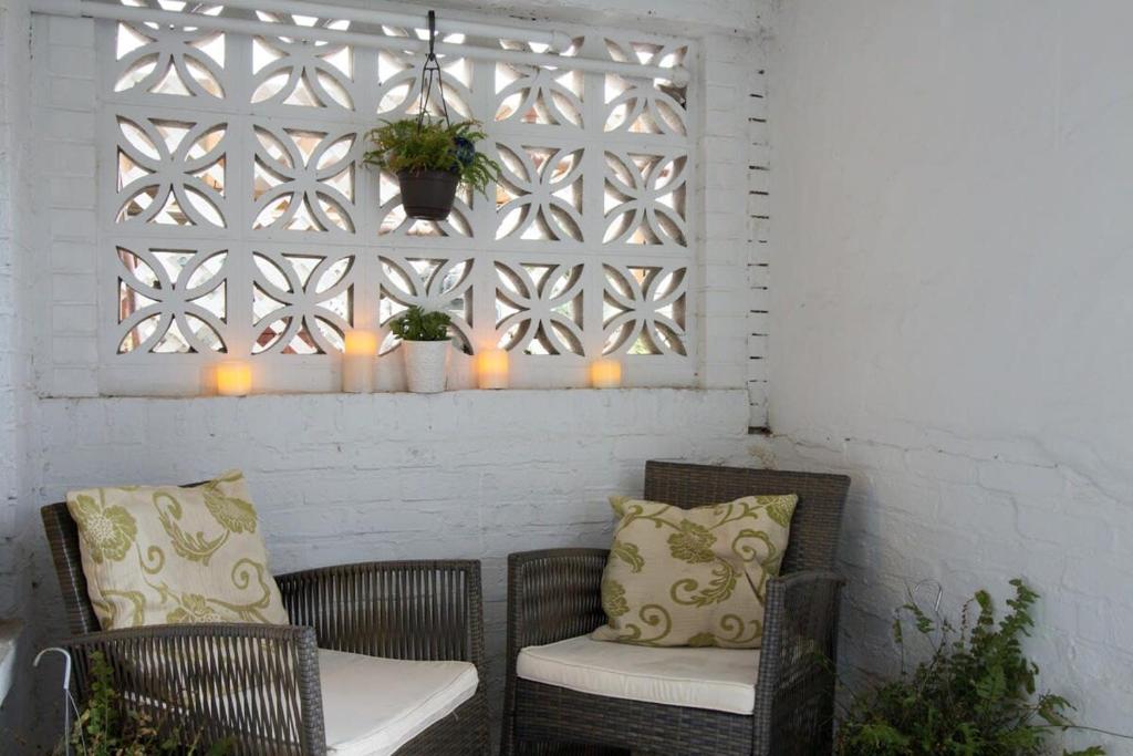 a patio with two chairs and a window with candles at Delightful 1-BR Accommodations Nearby METRO in Washington, D.C.