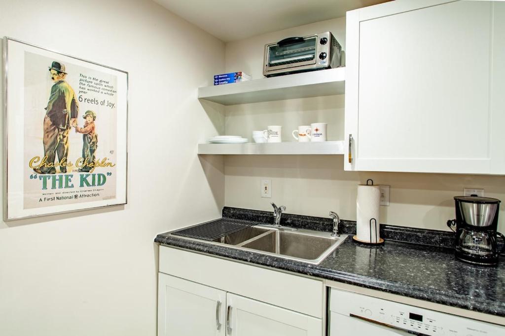 a kitchen with a sink and a microwave at Stay Cozy in CoHi DC in Washington, D.C.