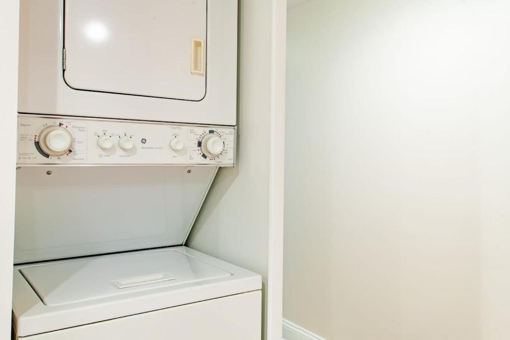 a white washer and dryer in a small kitchen at Stay Cozy in CoHi DC in Washington, D.C.