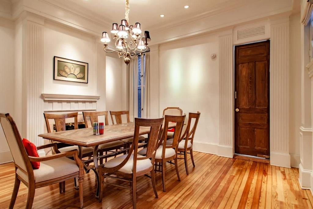 a dining room with a table and chairs and a chandelier at LUXE Kalorama 5-BR Townhome Close to Dupont Circle in Washington, D.C.