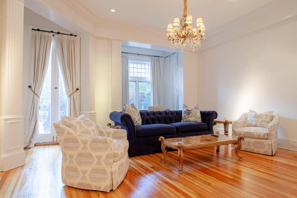 a living room with a couch and chairs and a chandelier at LUXE Kalorama 5-BR Townhome Close to Dupont Circle in Washington, D.C.