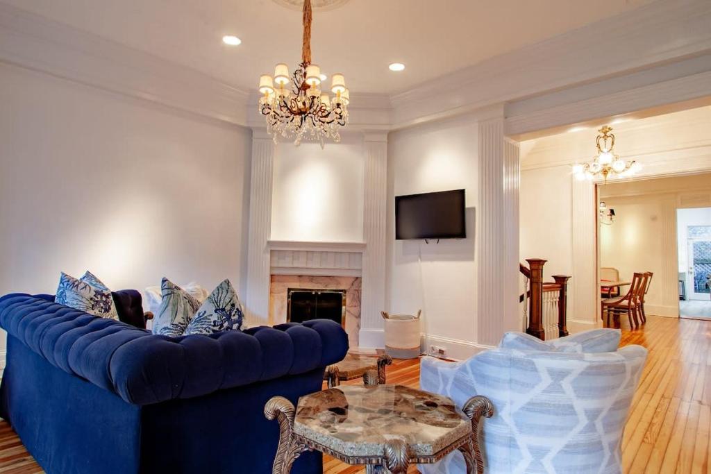 a living room with a blue couch and a table at LUXE Kalorama 5-BR Townhome Close to Dupont Circle in Washington, D.C.