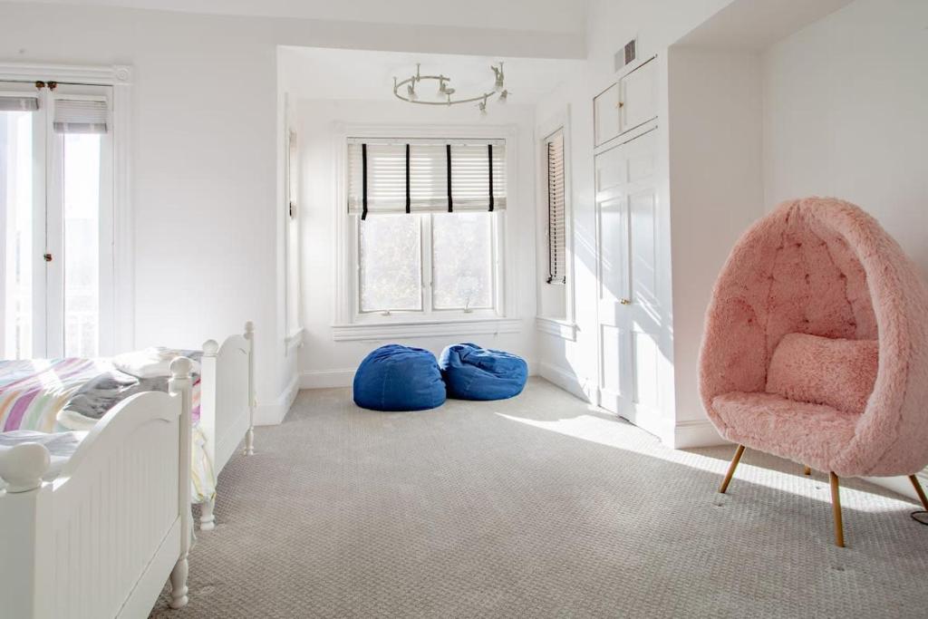 a bedroom with a pink chair and two bean bags at LUXE Kalorama 5-BR Townhome Close to Dupont Circle in Washington, D.C.