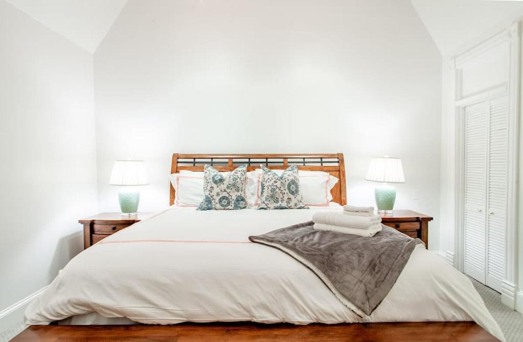 a white bedroom with a large bed with pillows at LUXE Kalorama 5-BR Townhome Close to Dupont Circle in Washington, D.C.