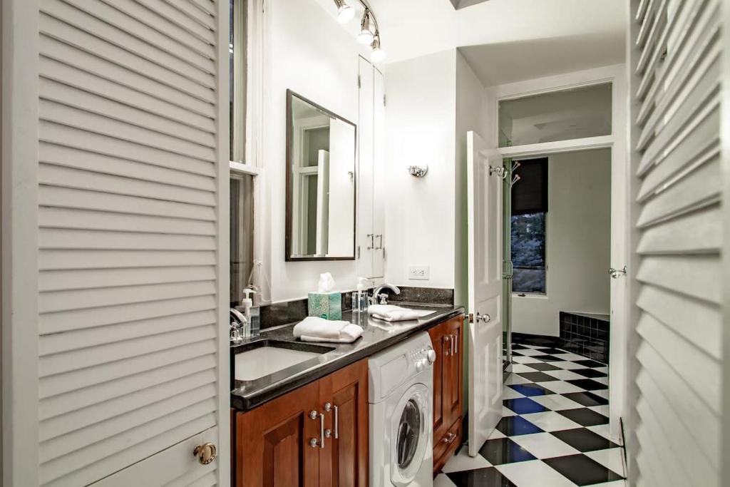 a bathroom with a sink and a washing machine at LUXE Kalorama 5-BR Townhome Close to Dupont Circle in Washington, D.C.