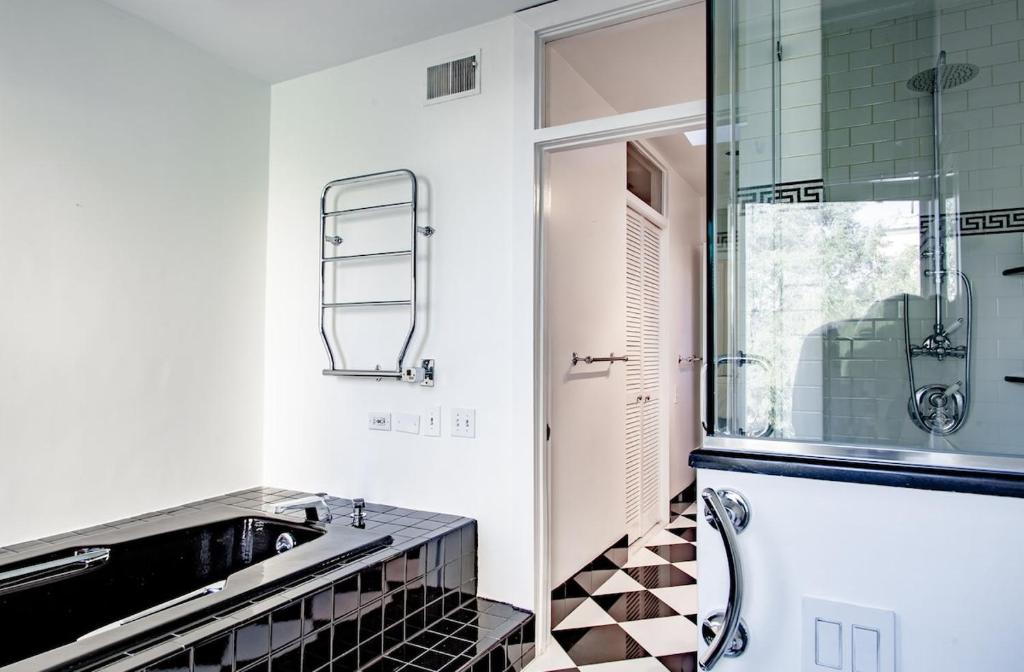 a bathroom with a sink and a glass shower at LUXE Kalorama 5-BR Townhome Close to Dupont Circle in Washington, D.C.