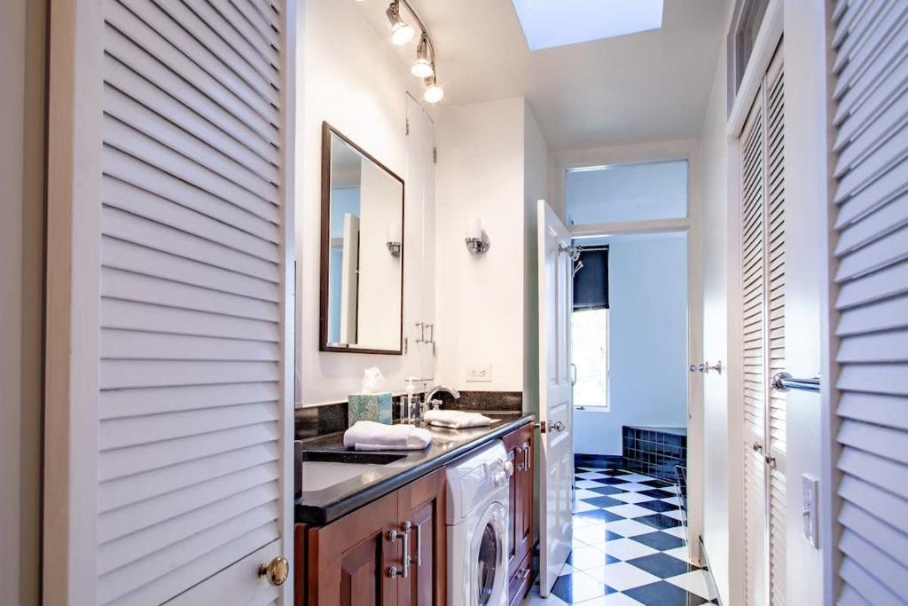 a bathroom with a sink and a mirror at LUXE Kalorama 5-BR Townhome Close to Dupont Circle in Washington, D.C.