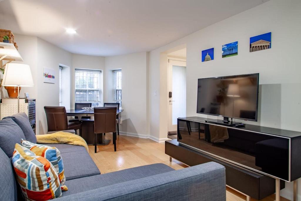 a living room with a couch and a flat screen tv at Gem off of 14th St NW Near U St & Logan Circle in Washington