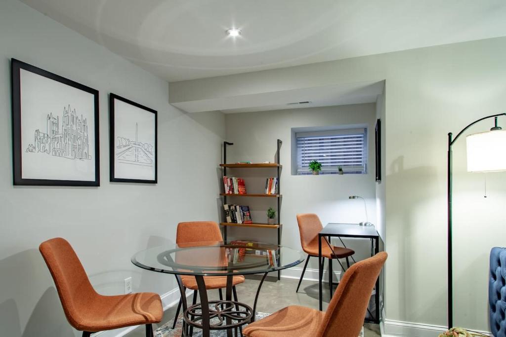a dining room with a glass table and chairs at 2-BR Petworth Pad Walk to METRO Subway in Washington, D.C.