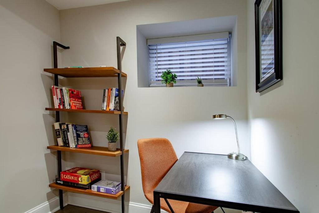 a table and a chair in a room with a window at 2-BR Petworth Pad Walk to METRO Subway in Washington, D.C.