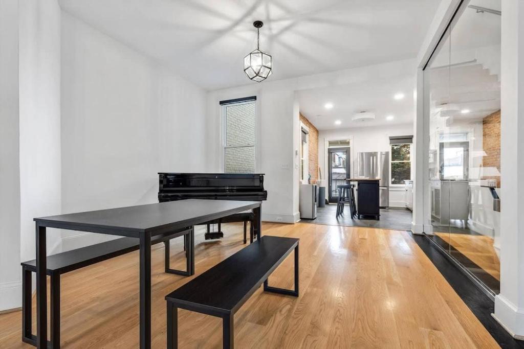 a dining room with a black table and a living room at H St DC Haven 4-BR Homestay in Washington, D.C.