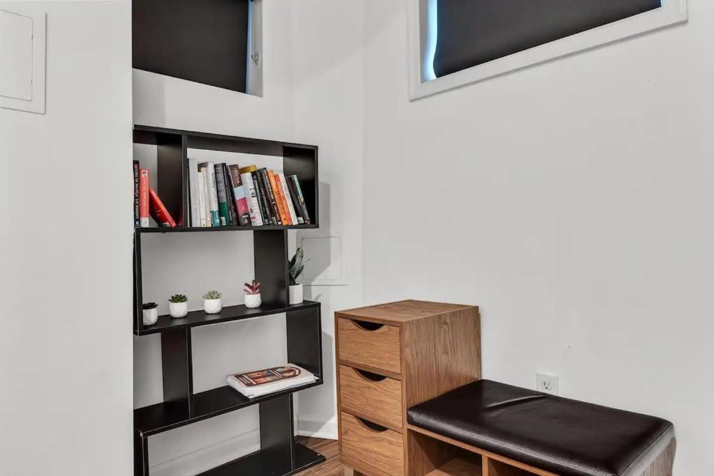 a room with a book shelf and a stool at H St DC Haven 4-BR Homestay in Washington, D.C.