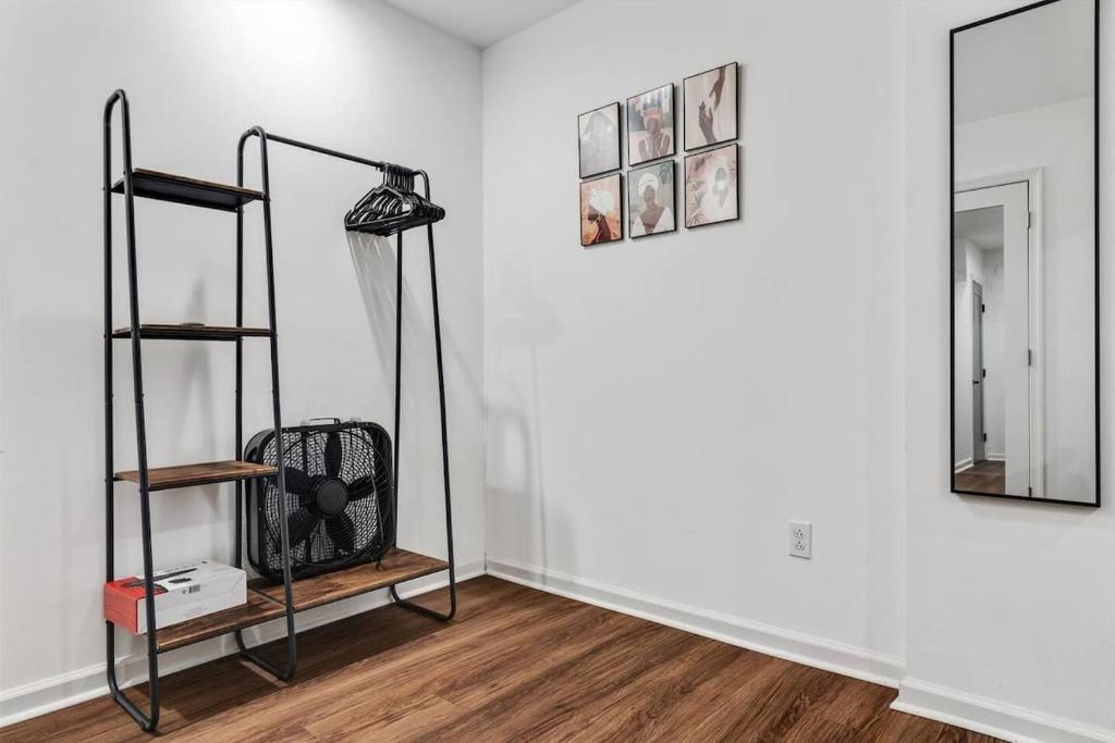 a white room with a mirror and a shelf at H St DC Haven 4-BR Homestay in Washington, D.C.