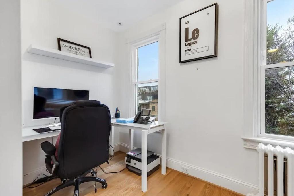 an office with a desk and a chair and a computer at H St DC Haven 4-BR Homestay in Washington, D.C.