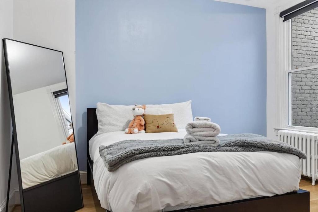 a bedroom with a large bed with a mirror at H St DC Haven 4-BR Homestay in Washington, D.C.