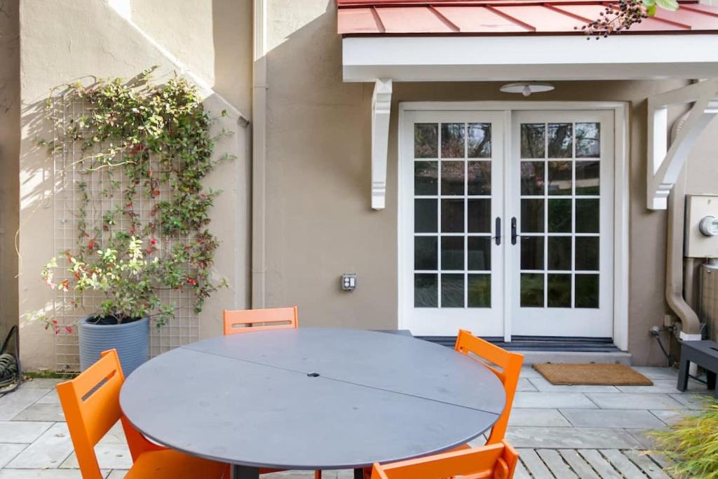 a white table and chairs in front of a house at Historic Charming Home in Old Town in Alexandria