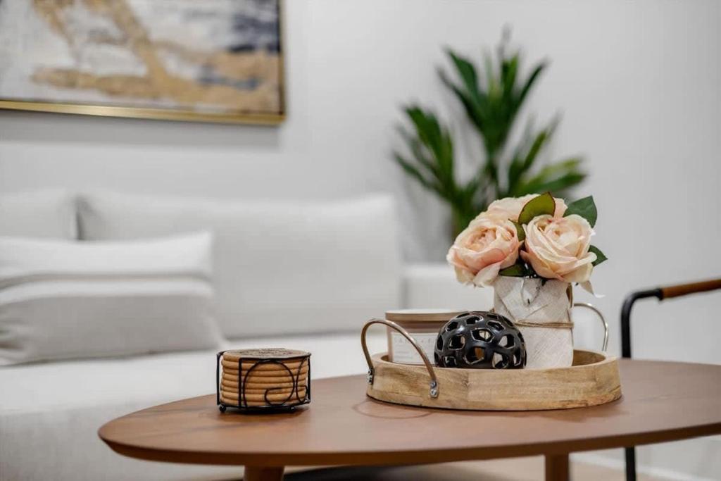 a table with a vase with flowers on it at Excellent 2-BR Condo in Hip Area of DC in Washington, D.C.