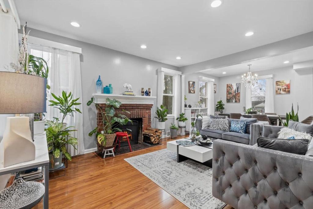a living room with a couch and a fireplace at Short Drive to Capitol Hill-Convenient MD Homestay in Capitol Heights