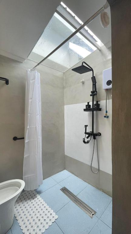 a bathroom with a shower and a toilet at Hayya Hayya Villas in Ocoy