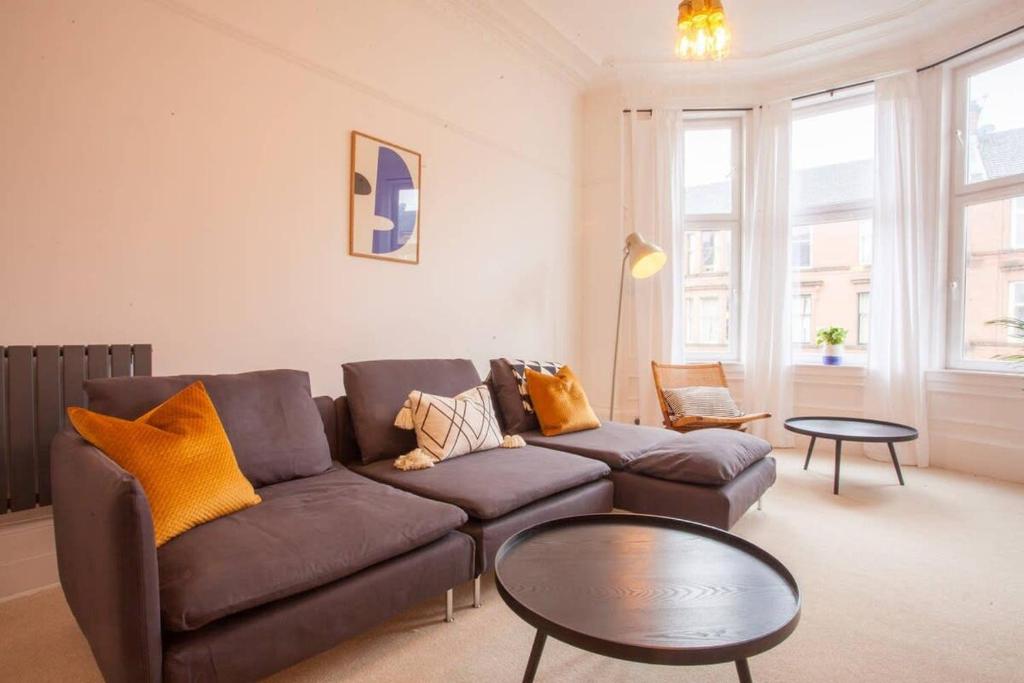 a living room with a couch and a table at Stunning 2 bed property in heart of West End in Glasgow