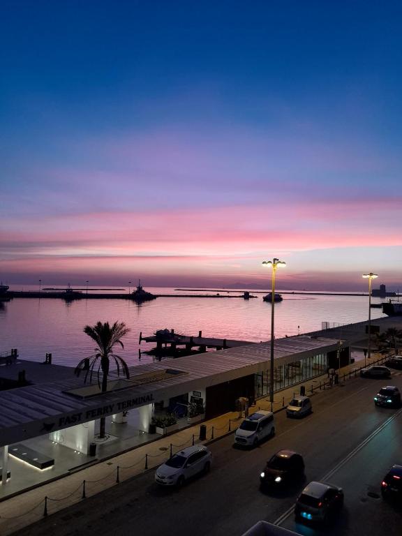 a parking lot with cars parked next to a body of water at B&B Belveliero - Il Capitano in Trapani