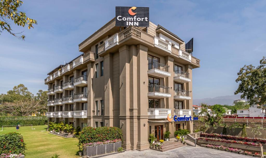 a building with a sign on top of it at Comfort Inn Dehradun in Dehradun