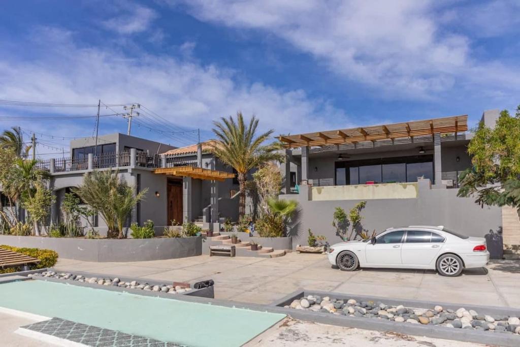 a white car parked in front of a house at Near Downtown w Views of Marina Puerto Los Cabos in La Choya