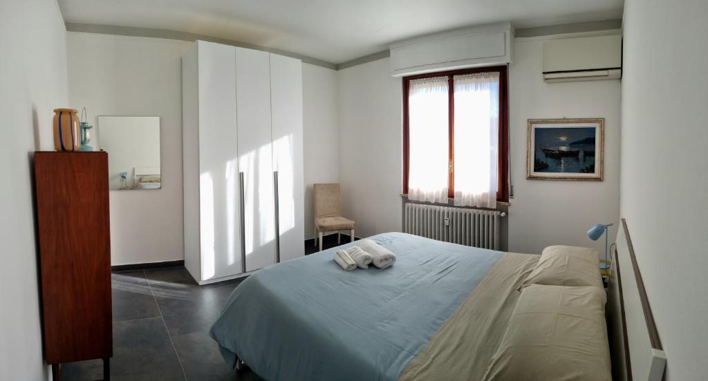 a bedroom with a bed with a towel on it at Sunbath House Pisa - Free Parking - Near Pisa Center in Pisa