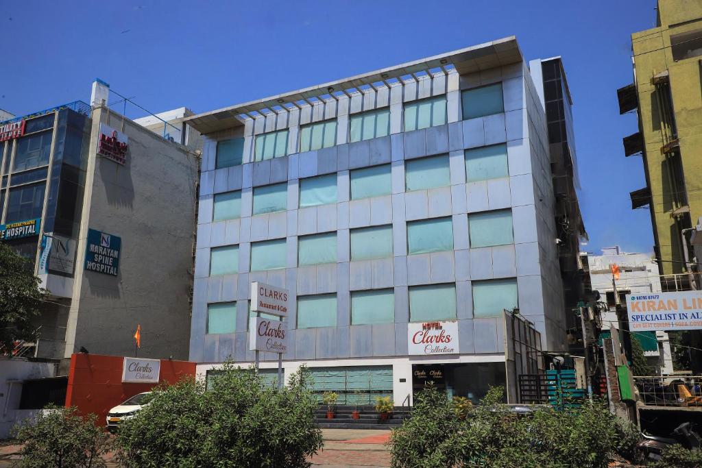 a building with a car parked in front of it at Hotel Clarks Collection Vadodara in Vadodara