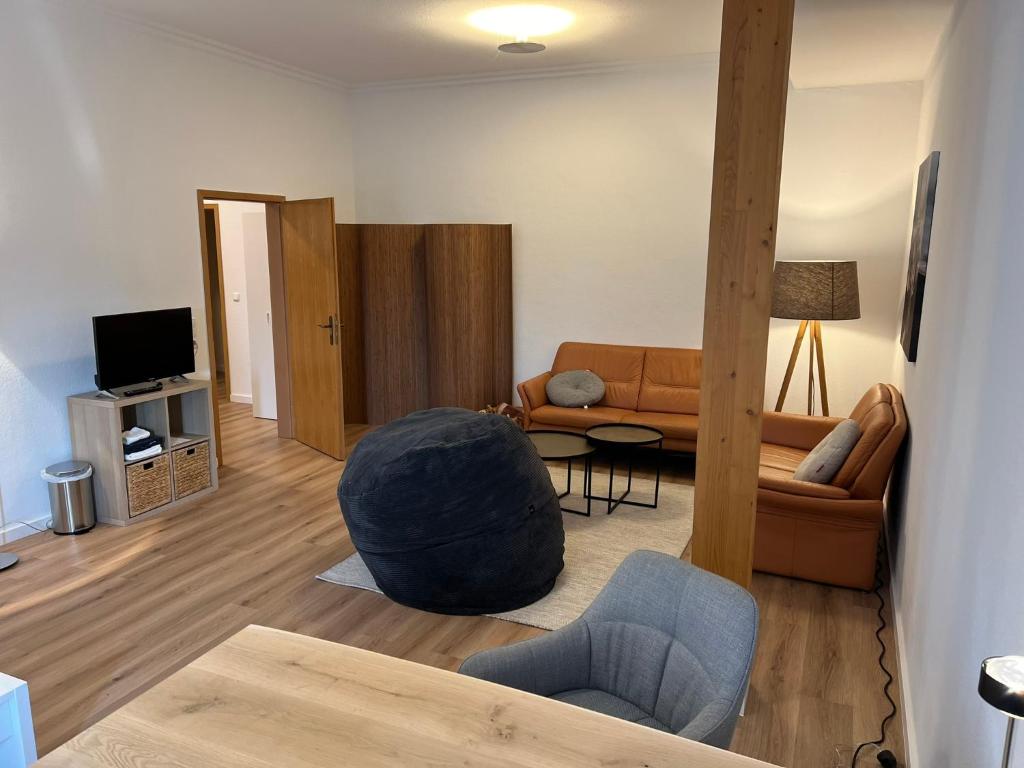 sala de estar con sofá y silla en Messewohnung für 2, en Giesen