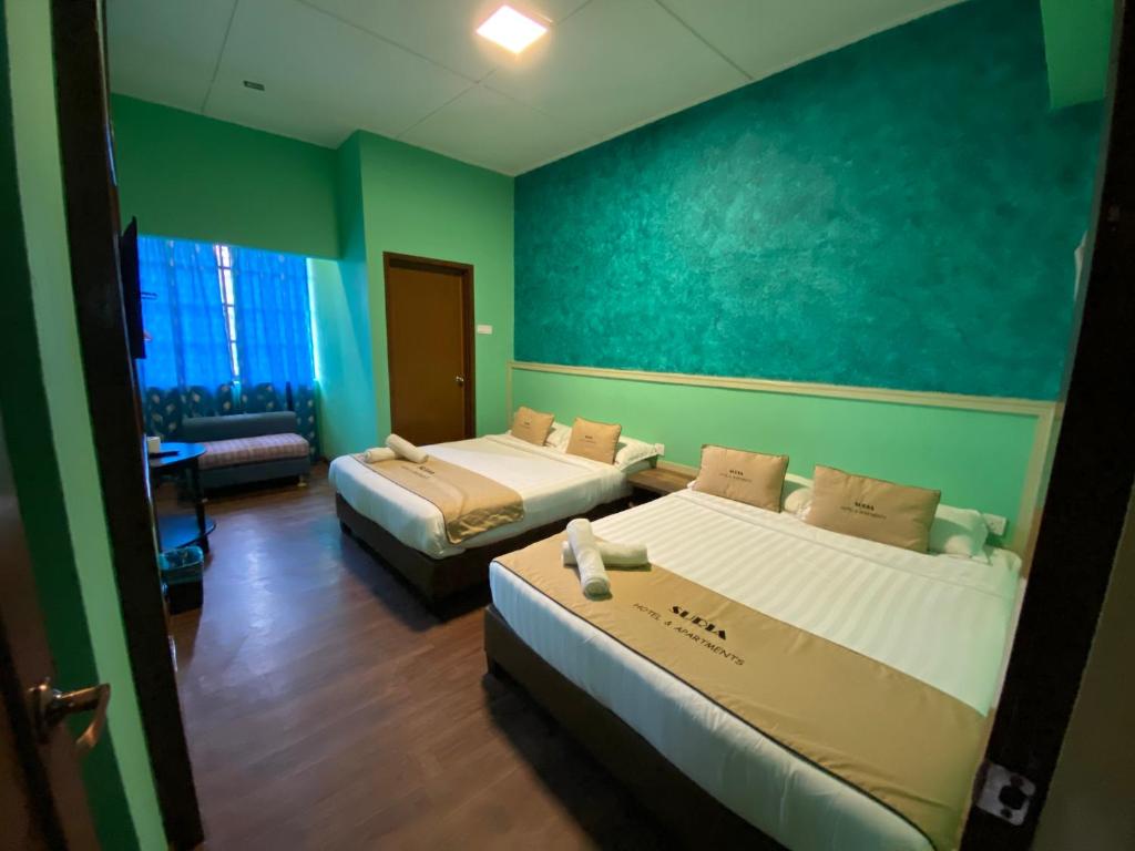 Postel nebo postele na pokoji v ubytování Suria Cameron Hotel