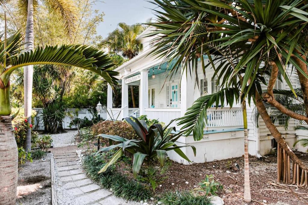 a white house with palm trees in front of it at King Suite Balcony by Brightwild- at James House in Key West