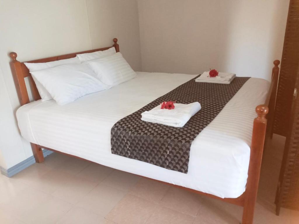 a bedroom with a bed with two towels on it at Lelago Eco Lodge in Apia
