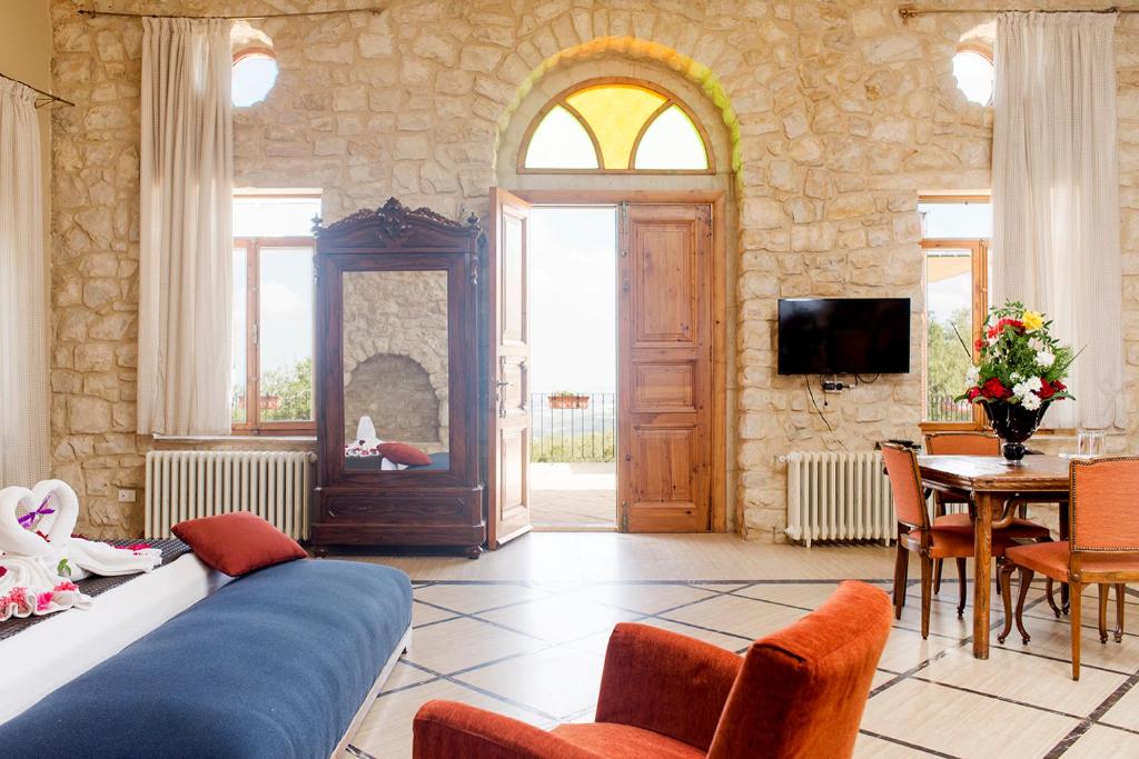 a living room with a couch and a table and a tv at Abdelli Terraces in Batroun in Batroûn