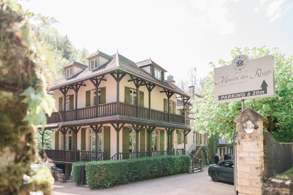 a large house with a sign in front of it at Le Moulin Des Ruats in Avallon