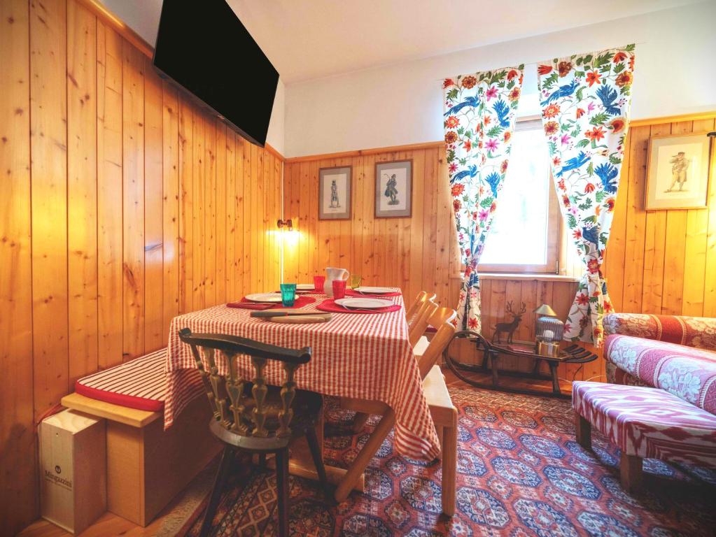 een woonkamer met een tafel en een bank bij Casetta sul Lago di Misurina in Misurina