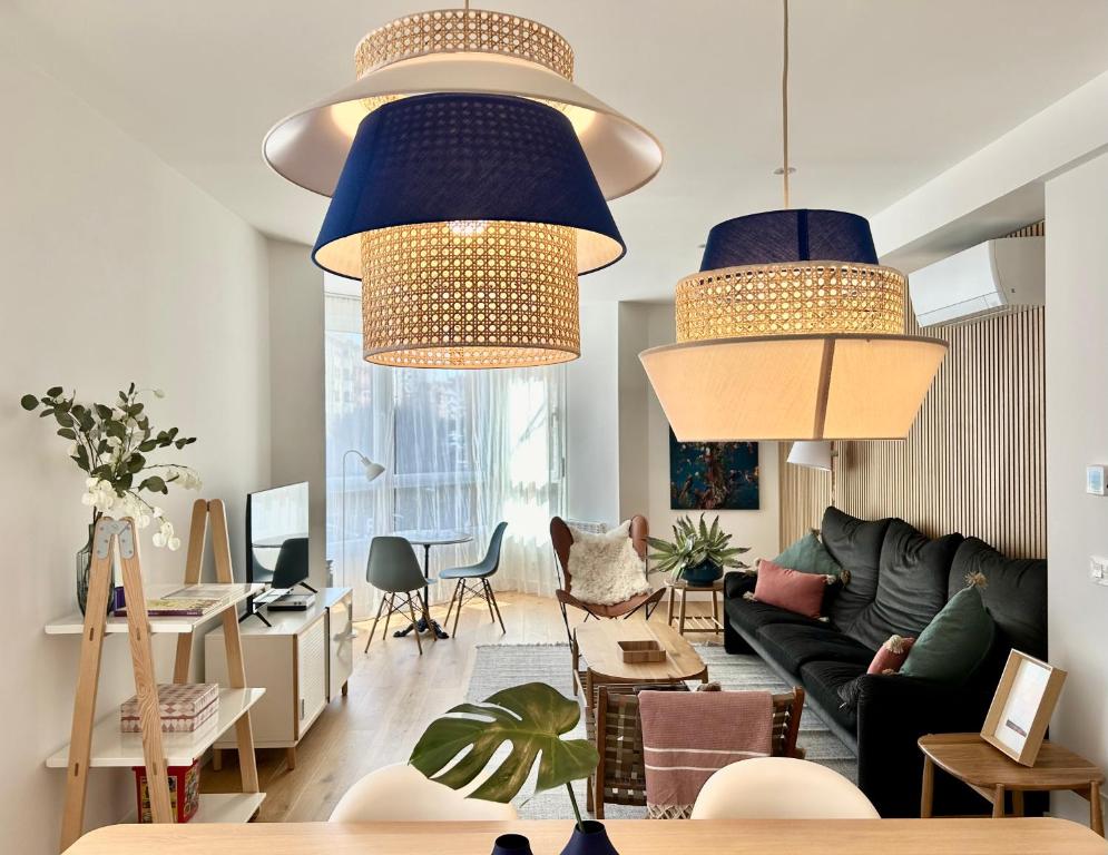 a living room with two blue pendant lights at Plaza Tomás in Pamplona