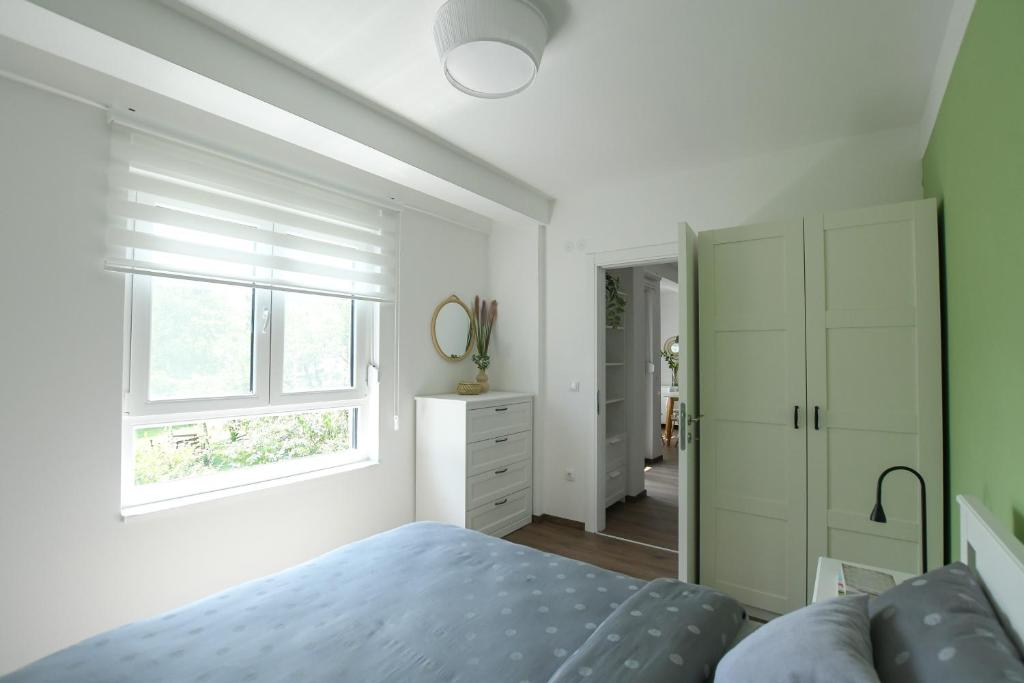 a bedroom with a bed and a window at Apartman Plaža 2 in Kladovo