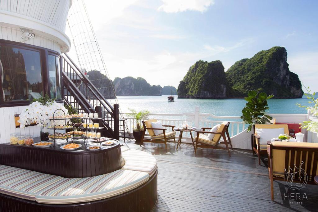 a balcony on a cruise ship with a view of the water at Hera Grand Luxury Cruise in Ha Long