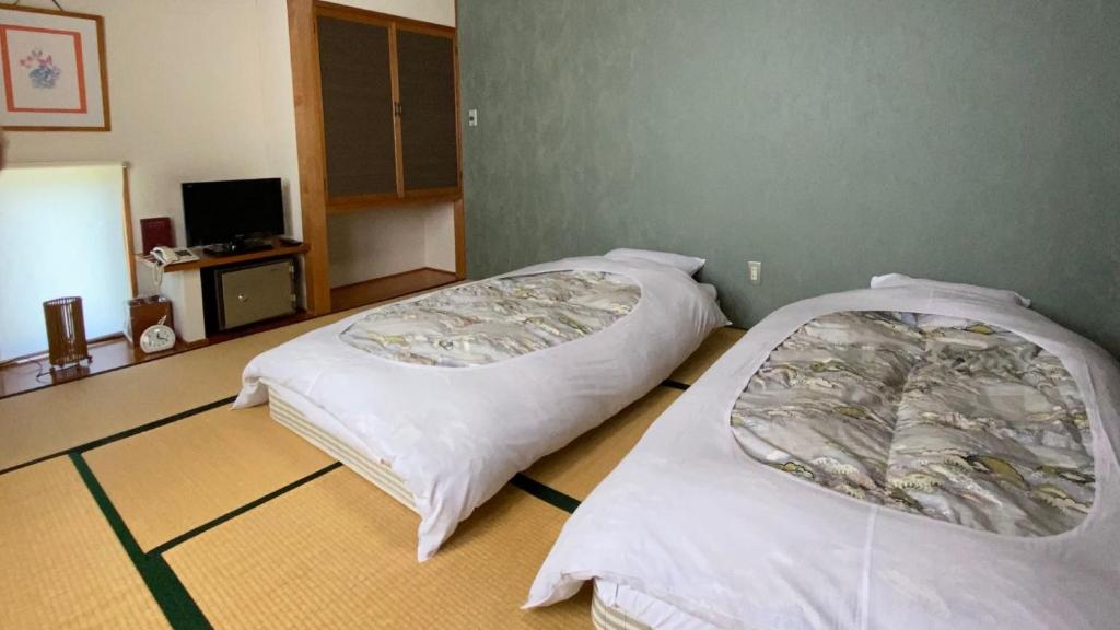 Postel nebo postele na pokoji v ubytování Hotel Yume-no-yu