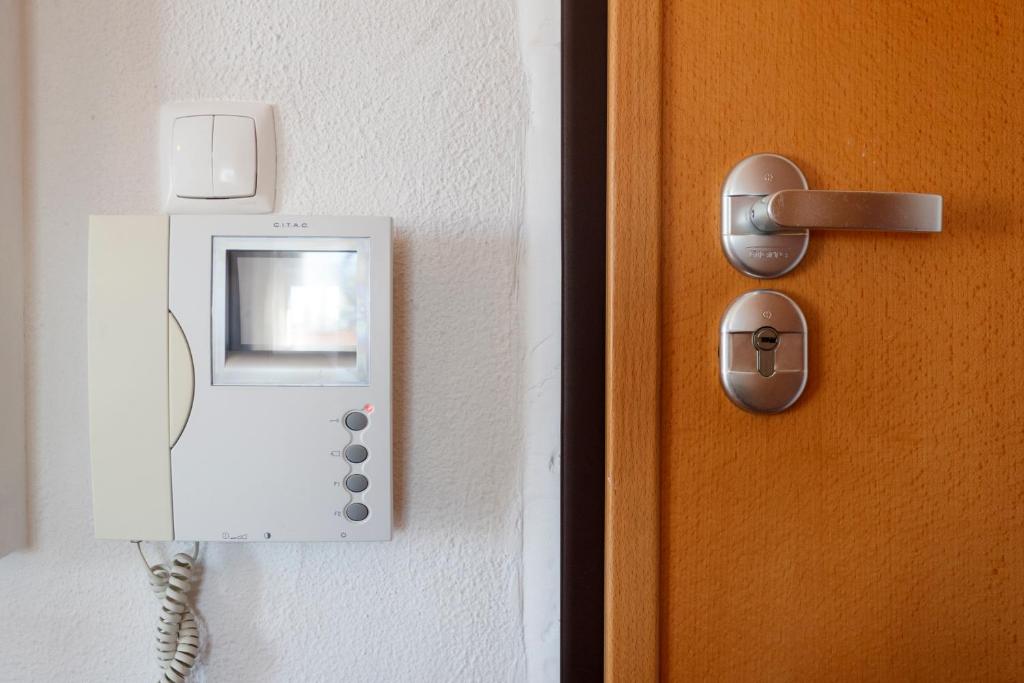 a door with a phone on a wall at Beach House Cascais in Estoril