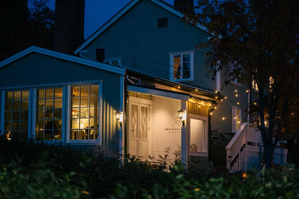 a house with lights on the side of it at night at Hotell Åre Fjällsätra in Undersåker