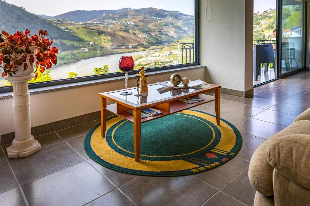 a living room with a coffee table in front of a window at Fraga Douro House, Douro Valley in Resende