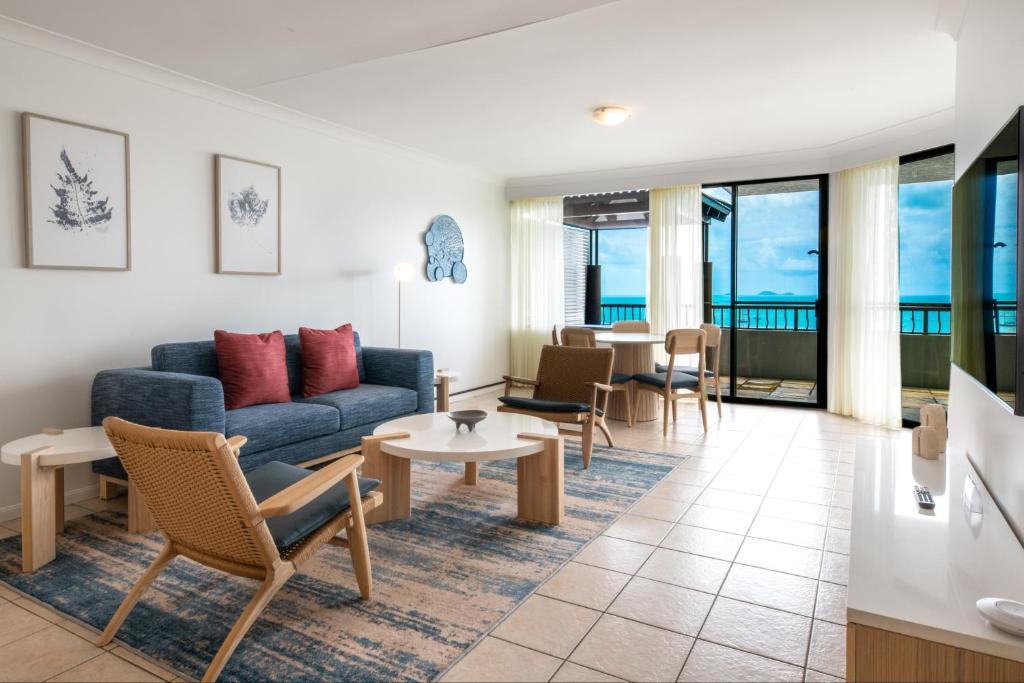 a living room with a couch and a table at at Water's Edge Resort in Airlie Beach