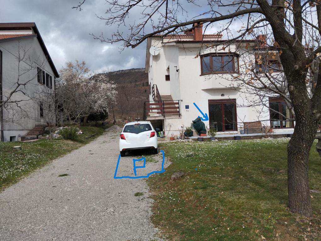 a white car parked in front of a house at DAAL in Roč