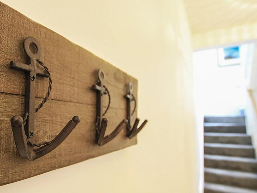 a wall with three anchors on a wall at Waterside - Luxury Menai Bridge Holiday Home - 4 Bed 4 Bath in Menai Bridge
