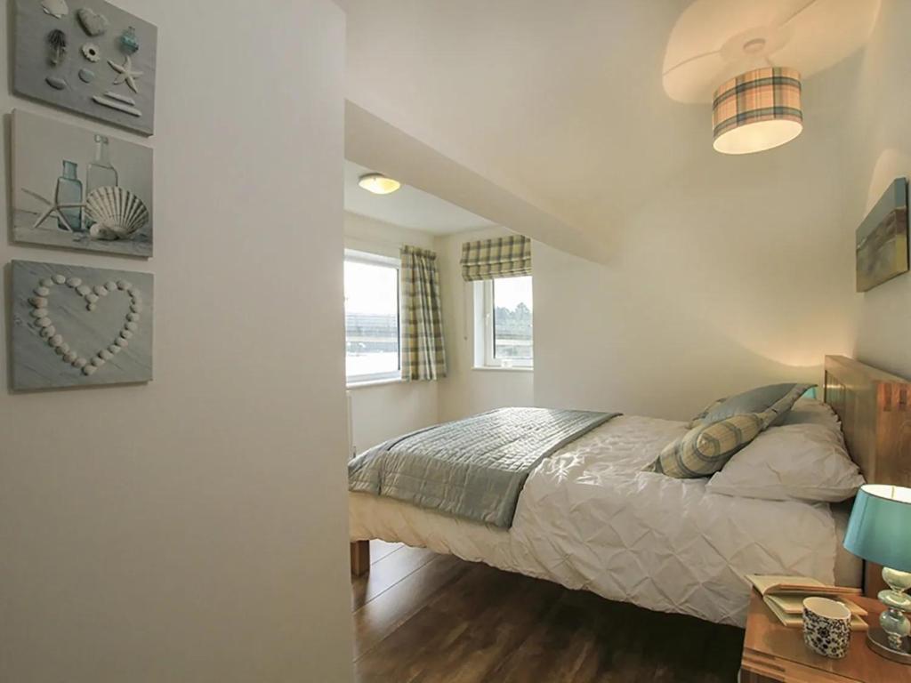 a bedroom with a bed and a window at Waterside - Luxury Menai Bridge Holiday Home - 4 Bed 4 Bath in Menai Bridge