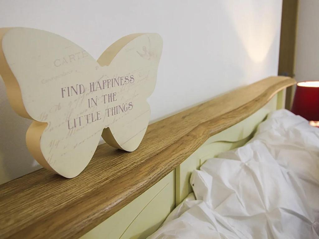a bed with a heart sign on top of it at Waterside - Luxury Menai Bridge Holiday Home - 4 Bed 4 Bath in Menai Bridge