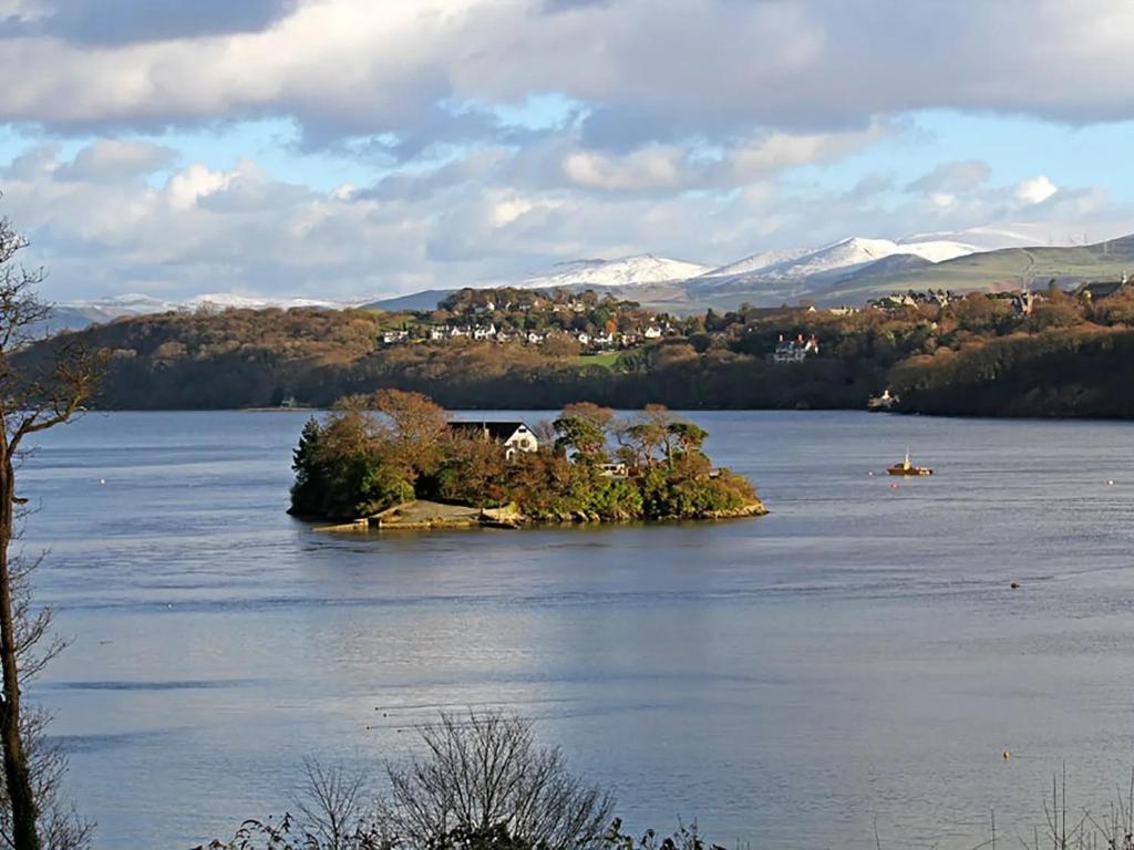 a small island in the middle of a lake at Waterside - Luxury Menai Bridge Holiday Home - 4 Bed 4 Bath in Menai Bridge