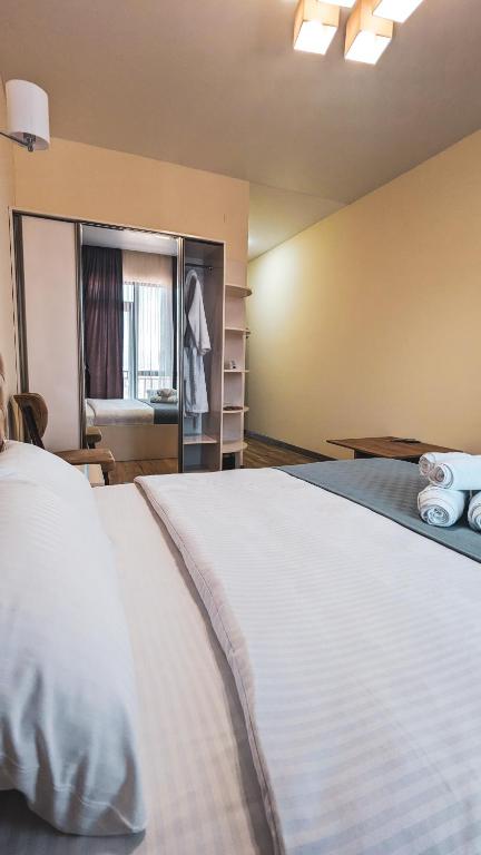 Postel nebo postele na pokoji v ubytování GG ApartHotel